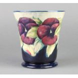 A 1920's William Moorcroft tapered vase decorated with pansies, signature mark to base 6 1/2"
