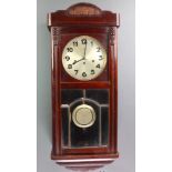 A chiming wall clock with 8" silver dial and Arabic numerals contained in a mahogany case