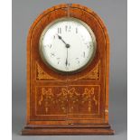 A bedroom timepiece with enamelled dial and Arabic numerals contained in an inlaid mahogany case.