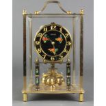 Kundo, a 400 day clock with gilt lacquered and floral painted dial contained in a square case