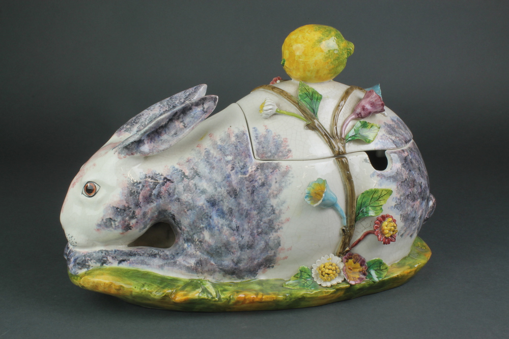 A 20th Century Continental tureen in the form of a seated rabbit encrusted with flowers and having a