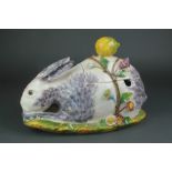 A 20th Century Continental tureen in the form of a seated rabbit encrusted with flowers and having a