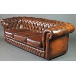 A Chesterfield 3 seat settee upholstered in brown buttoned leather 27"h x 81"w x 34"d