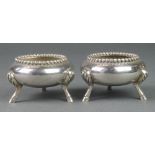 A pair of Victorian silver squat table salts with beaded rim and hoof feet, London 1865, 186 grams