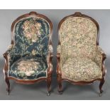 A pair of Victorian carved rosewood show frame tub back chairs upholstered in floral material and