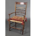 An elm bar back chair with bobbin turned decoration and woven rush seat