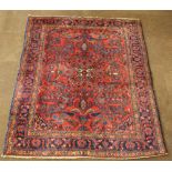 A Persian Lilian rug with blue ground and floral pattern 79" x 62"