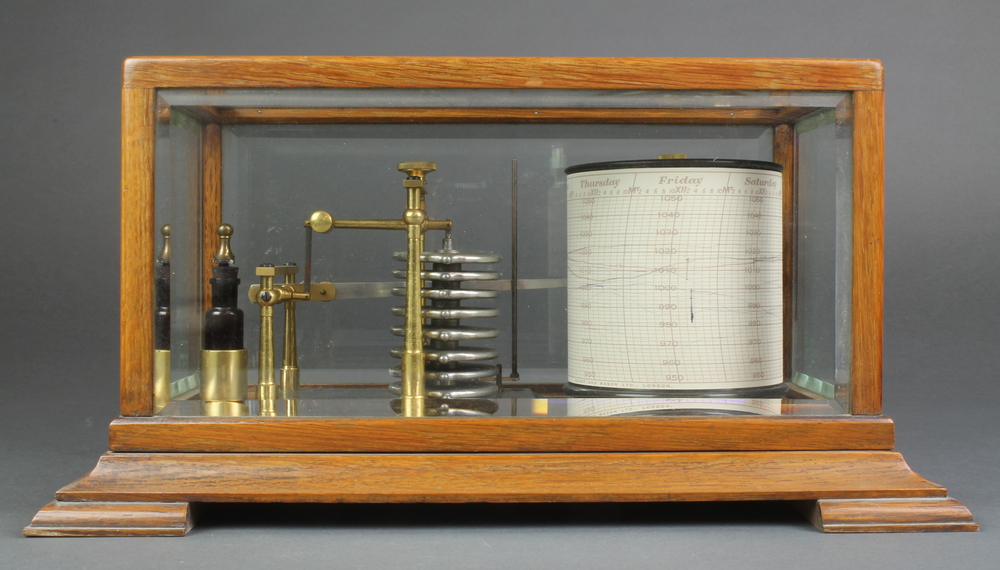 An Edwardian barograph contained in an oak and bevelled glass case, the top of the barrel marked