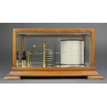 An Edwardian barograph contained in an oak and bevelled glass case, the top of the barrel marked
