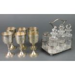 An Edwardian silver plated 6 bottle cruet stand and 6 plated gobles