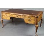 A French Queen Anne style shaped writing table with inset brown leather writing surface above 1 long