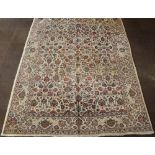A Persian Tabriz carpet with white and floral ground, some wear 127" x 86"