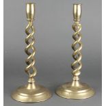 A pair of brass spiral candlesticks on circular bases 12"