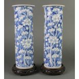 A pair of early 20th Century Chinese prunus cylindrical vases with flared necks 12" with 4 character