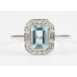 A white gold aquamarine and diamond Art Deco style ring, the centre baguette cut stone enclosed by