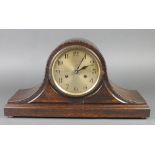 An Art Deco 8 day striking mantel clock with silvered dial and Arabic numerals contained in an oak