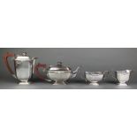 A silver 4 piece tea and coffee set with fruitwood handles and cast scroll decoration Birmingham