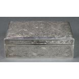 A 20th Century Egyptian silver rectangular cigarette box with chased scroll decoration 5 3/4" x 4"