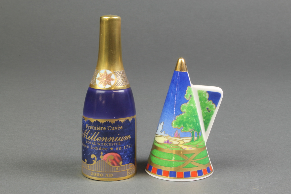 A Royal Worcester candle snuffer to celebrate the Millennium in the form of a champagne bottle 4 1/