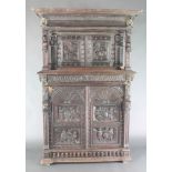 A Victorian carved oak cabinet on cabinet, the upper section with moulded and carved cornice, fitted