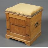 A Victorian Arts & Crafts square oak ottoman with hinged lid and brass drop handles, raised on