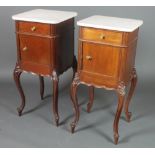 A pair of 19th Century French mahogany bedside cabinets with white veined marble tops fitted