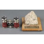 A pair of gilt metal opera glasses together with a section of granite removed from the old London