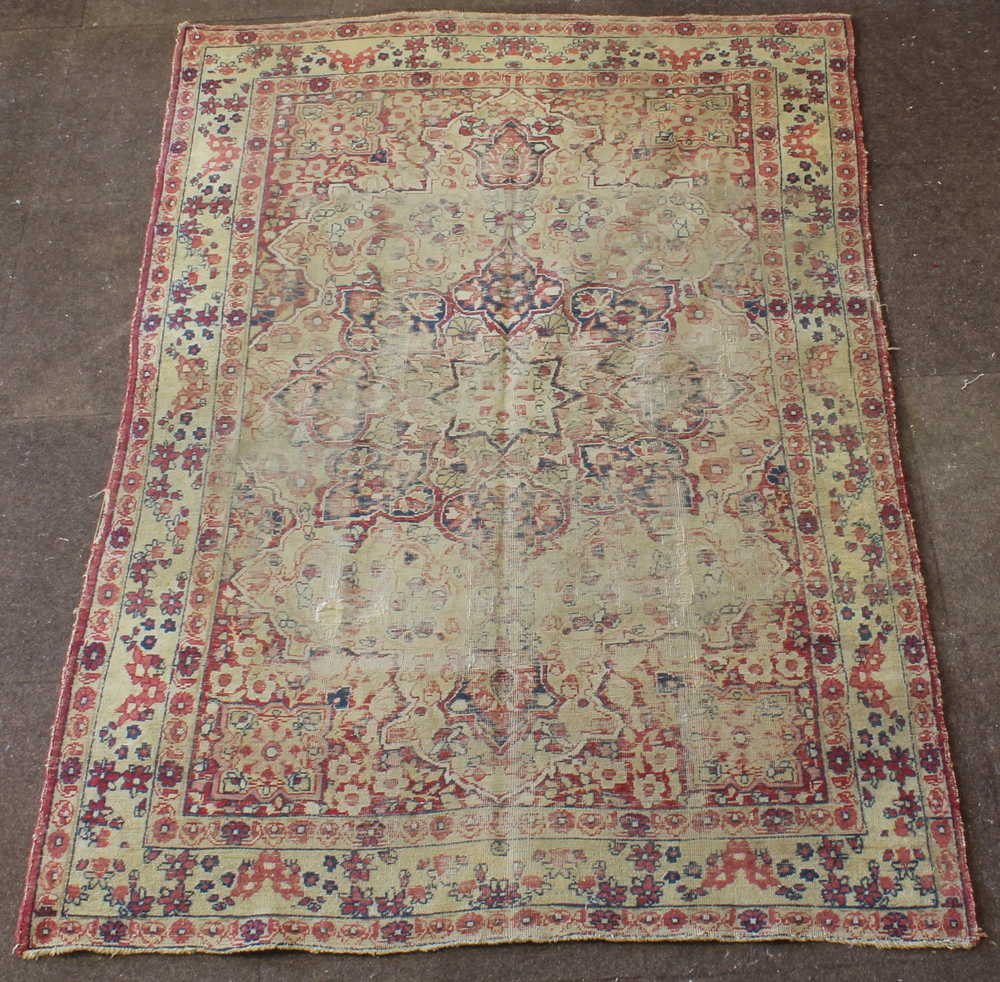 A Persian Bakhtiari rug with central medallion, in wear, 76" x 50"