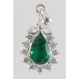 An 18ct white gold pear shaped emerald and diamond pendant, the emerald approx. 1.41ct surrounded by