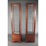 A pair of 20th Century rectangular mahogany pedestal shop display cabinets fitted shelves 76"h x