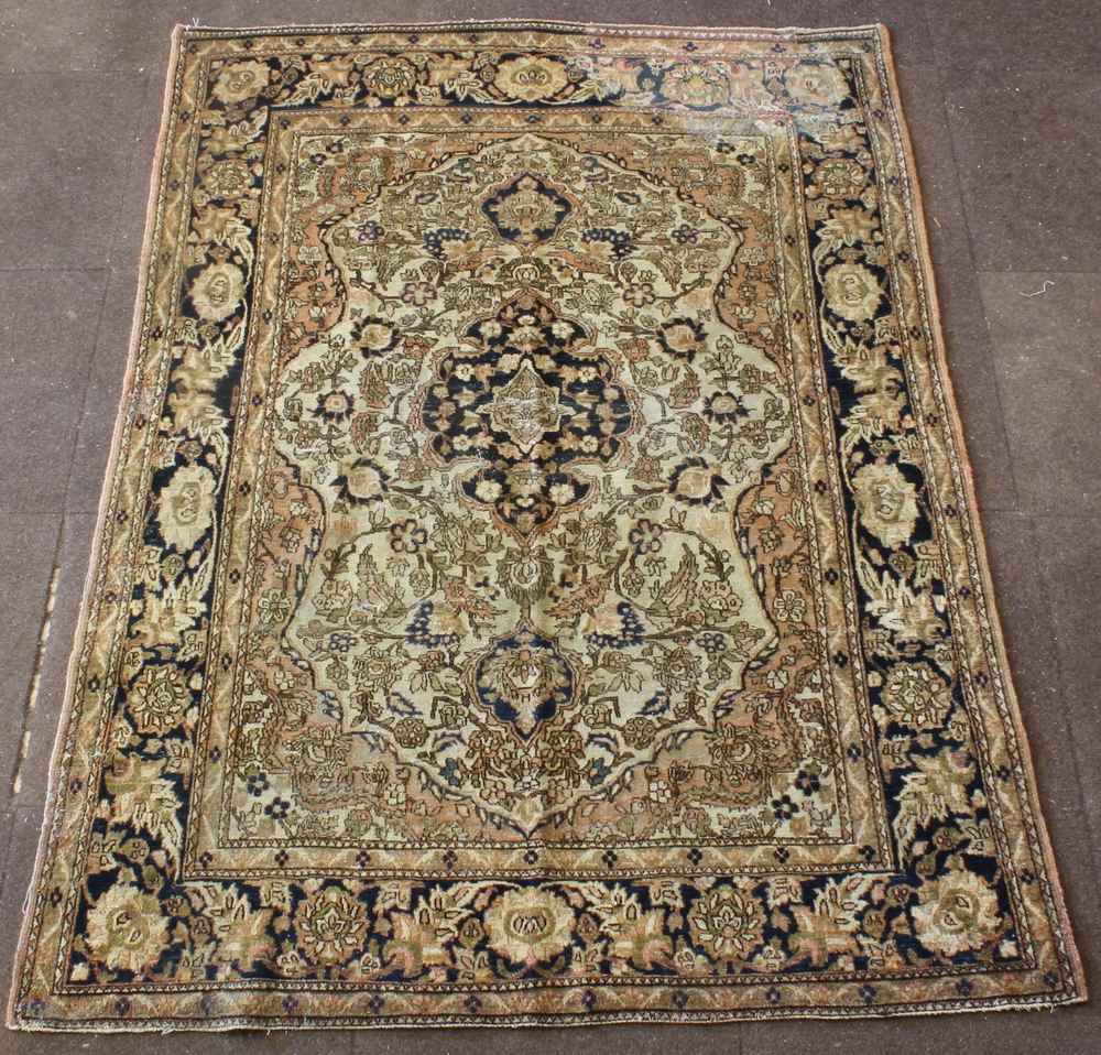 A Persian Tabriz rug with white and blue ground and central medallion, some wear 75" x 54"