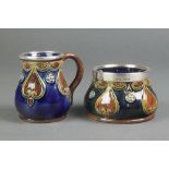 A Royal Doulton blue ground jug with geometric decoration having a silver lip, a matching sugar bowl