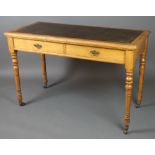 A Victorian ash writing table with green inset writing surface, fitted 2 long drawers and raised