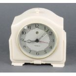 A Temco Art Deco electric alarm clock contained in an arched white Bakelite case