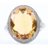 A 14ct white gold citrine and diamond cluster ring, the centre stone 9ct, surrounded by approx 0.