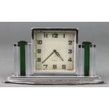 An Art Deco Continental 8 day bedroom timepiece with Arabic numerals contained in a chrome and glass