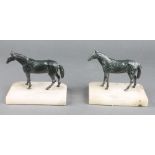 A pair of spelter and white metal bookends in the form of standing horses, raised on rectangular