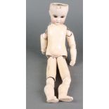 A porcelain headed doll with open eyes and open mouth with teeth,with articulated limbs, the body