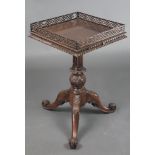 A Chippendale style square mahogany wine table with fret work gallery, raised on turned carved