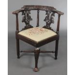 A 19th Century carved oak corner chair with pierced vase shaped slat back and drop in Berlin