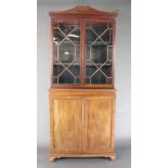 A 19th Century mahogany cabinet on cabinet, the upper section with moulded cornice, the interior