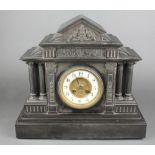 A Victorian striking 8 day mantel clock with porcelain dial and Arabic numerals contained in a black