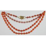 A Victorian coral necklace with an 18ct gold clasp and a matching 2 stone ring