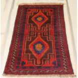 A red and blue ground Persian rug with 2 stylised diamonds to the centre within multi-row borders