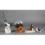 A Russian figure of a bear standing on a wheel 5 1/2", 2 Russian figures of birds and a reclining