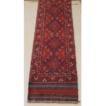 A Meshwani red and blue ground runner with 4 octagons to the centre 100" x 25"