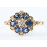 A yellow gold sapphire and diamond cluster ring with 6 brilliant cut sapphires surrounded by 11