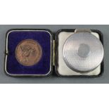 A silver engine turned pill box Birmingham 1913 28 grams and a cased bronze Royal Tournament medal