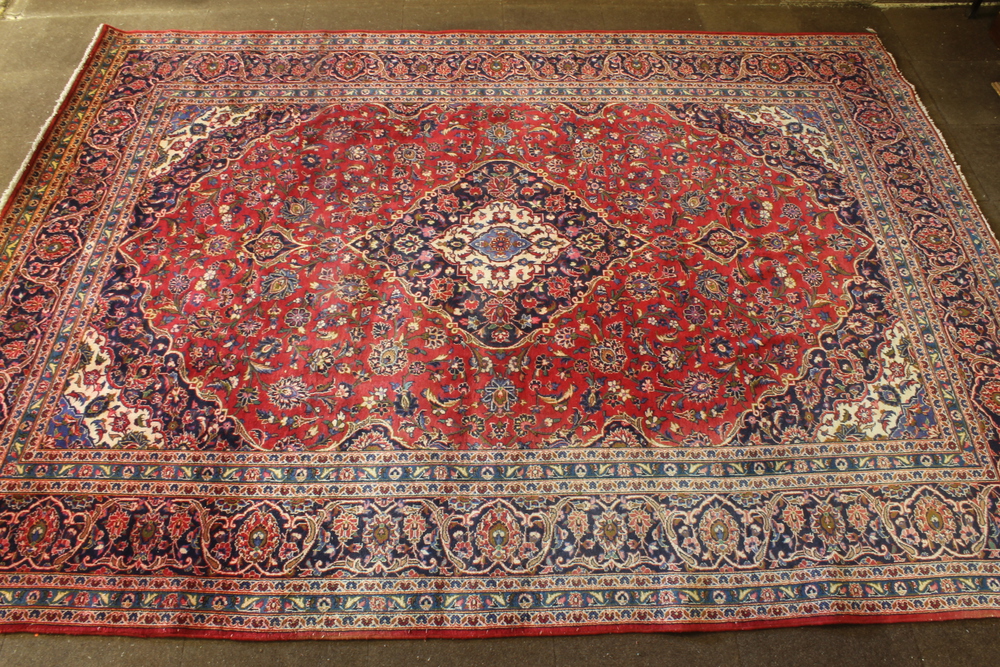 A red and blue ground Persian carpet with central medallion and floral ground 154" x 115"