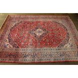 A red and blue ground Persian carpet with central medallion and floral ground 154" x 115"